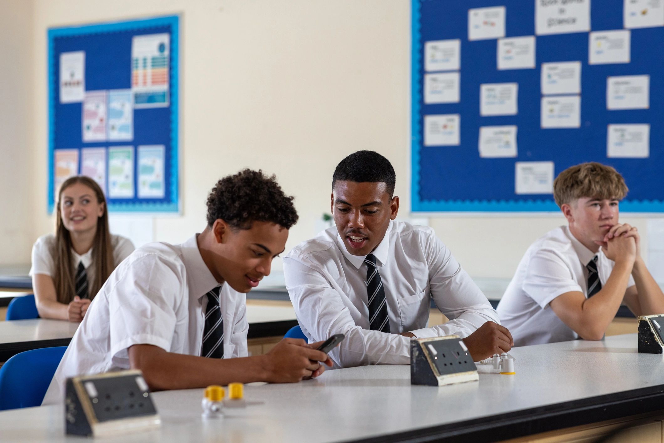 Students relaxing and collaborating in a classroom before class
