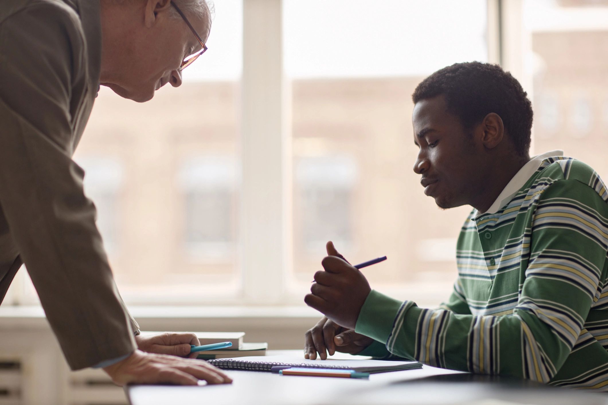 Teacher mentoring a student during a tutoring session
